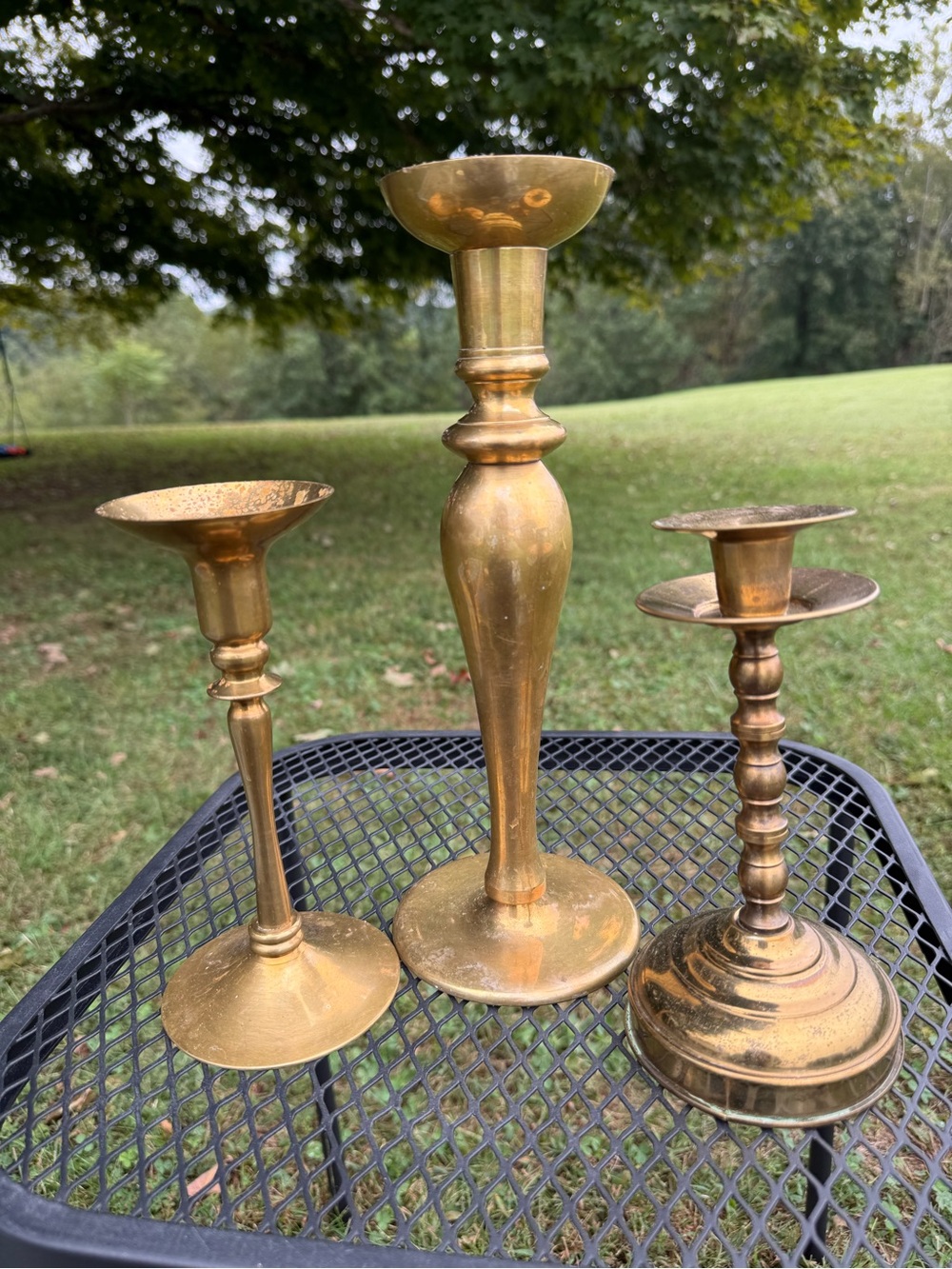 set of three vintage brass candlestick holders with mismatched styles
